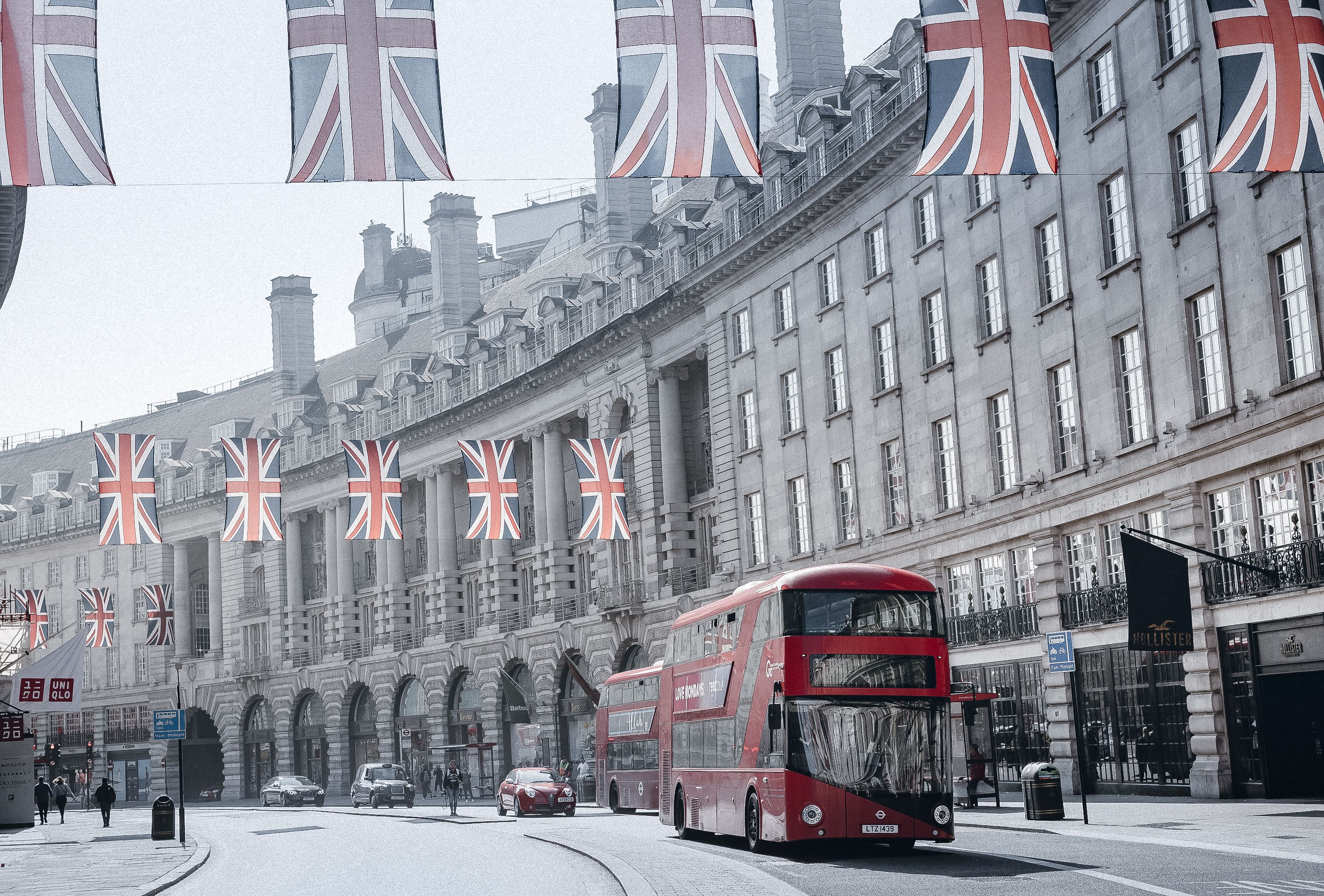 London street lined with grand Georgian hotel facades and Union Jack flags