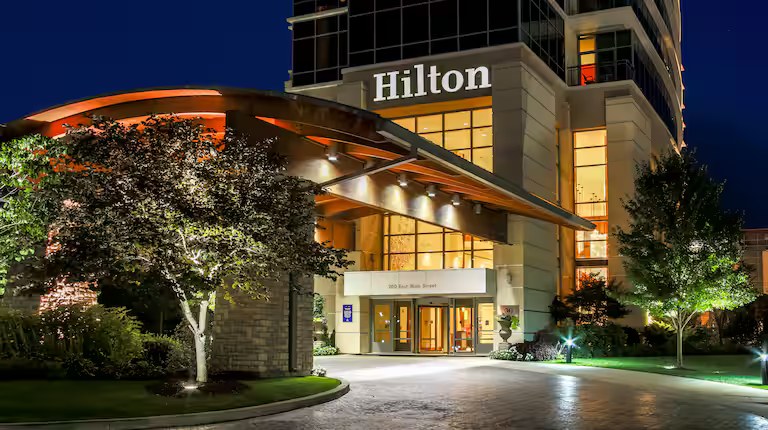 Hilton hotel entrance illuminated at night